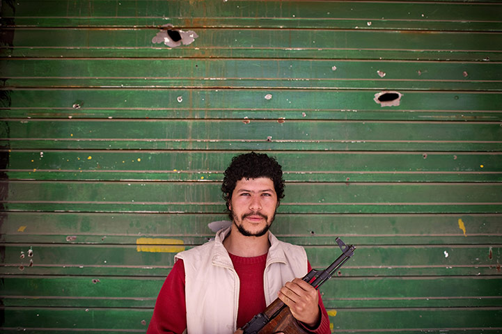  Misrata, Libya : Libyan shop owner who became a rebel stands in front of his shop