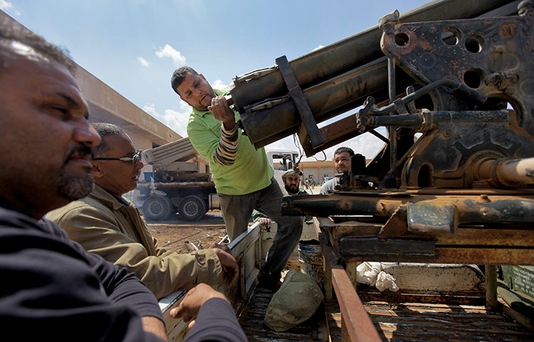 Libyan rebel workshop: Workmen prepare a Grad rocket launcher 