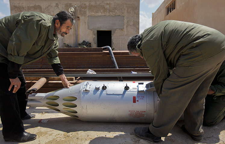 Libyan rebel workshop: Workmen examine a multiple rocket launcher 