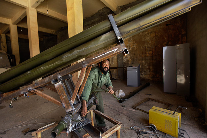 Libyan rebel workshop: A welder works at making a Grad rocket launcher