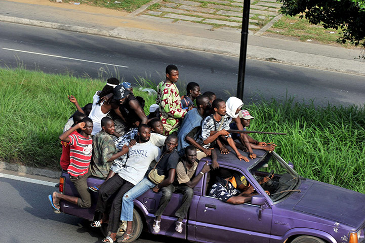 24 Hours in pictures: Millitiamen loyal to Alassane Ouattara drive a vehicle along a street