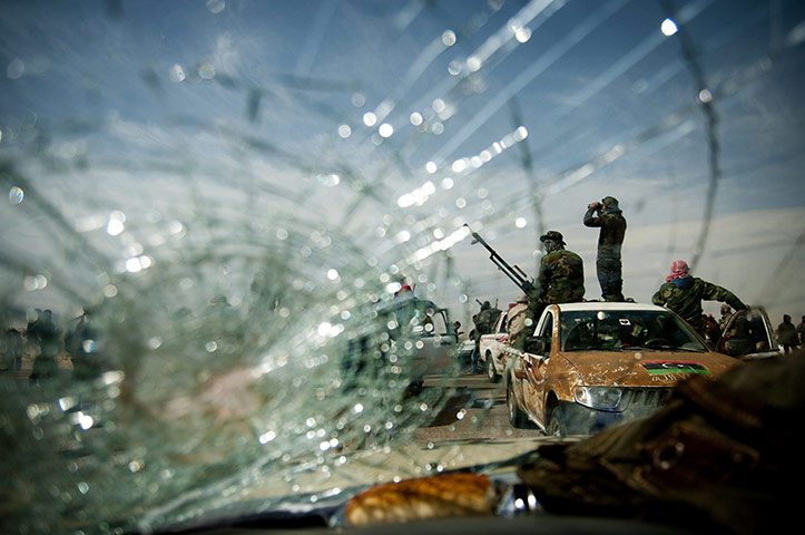 24 Hours in pictures: Rebels soldiers man a checkpoint near Brega