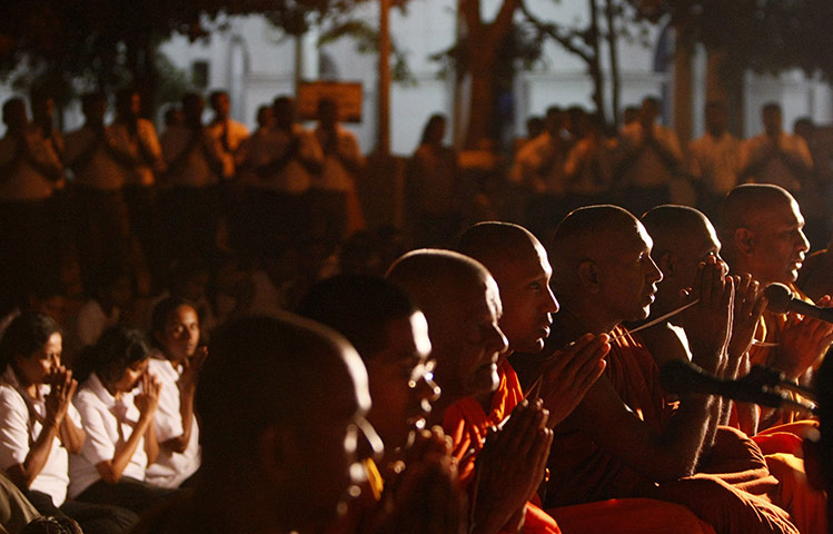 24 Hours in pictures: Buddhists monks lead prayers wishing success to the Sri Lankan team