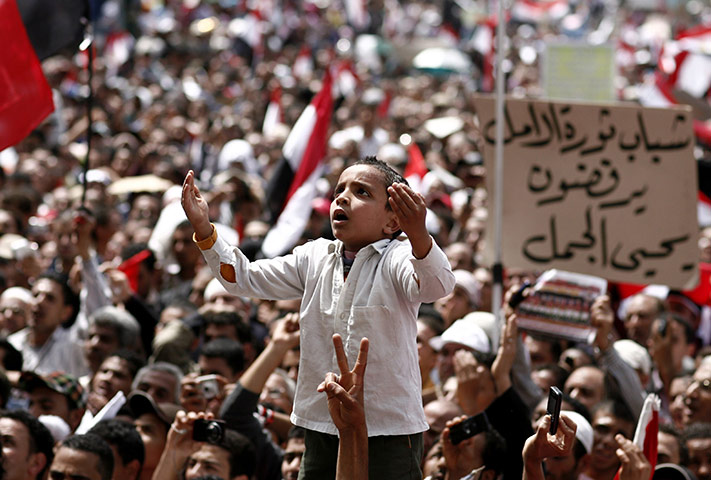 24 Hours in pictures: An Egyptian boy prays at Cairo's Tahrir Square