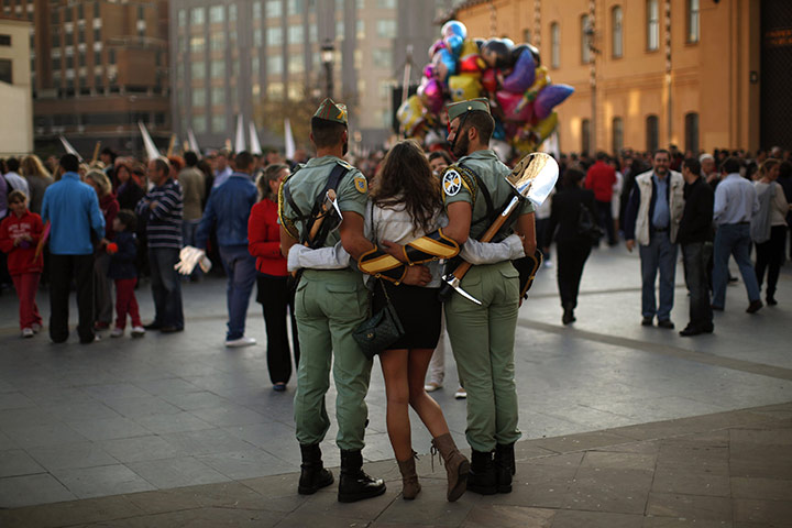 Holy Week in Malaga: Spanish legionnaires pose for a photo with a woman during Holy Week