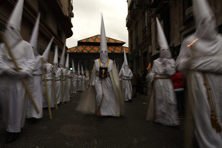 Holy Week in Malaga: Penitents take part in the procession of 