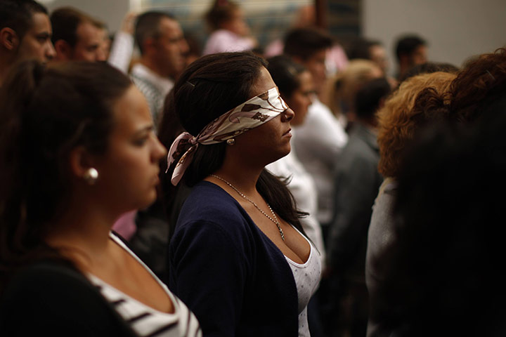 Holy Week in Malaga: A penitent walks blindfolded