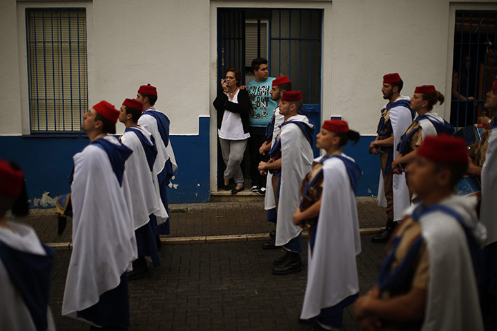 Holy Week in Malaga: People watch as soldiers wait for the start of a procession