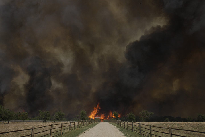 24 hours in pictures: Smoke rises from an uncontrolled wildfire  in Texas