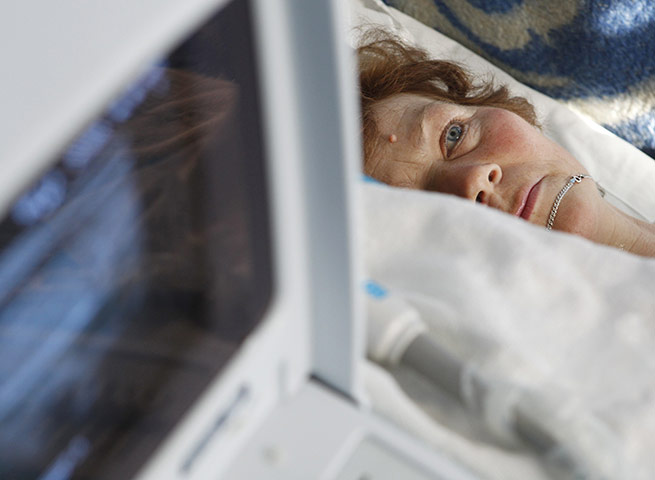 24 hours in pictures:  A woman is screened for thyroid cancer in  Ukraine