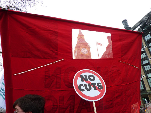 In pictures: cuts: Houses of parliament seen through banner