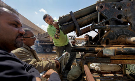 Libyan rebels prime a rocket launcher in Benghazi