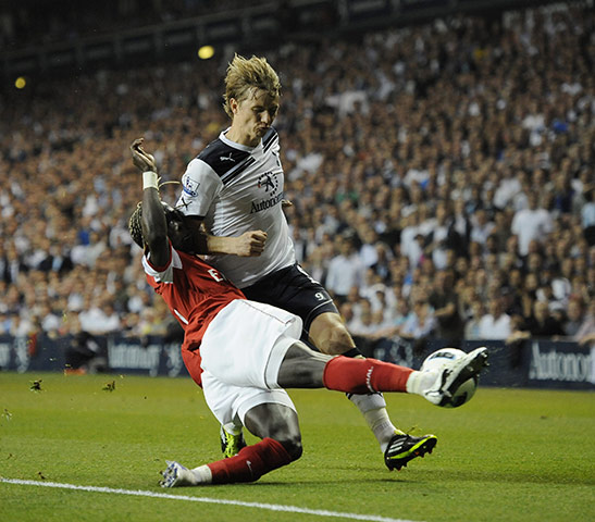 Spurs v Arsenal: Sanga receives an elbow in the chops as he slides in to tackle Pavlyuchenko