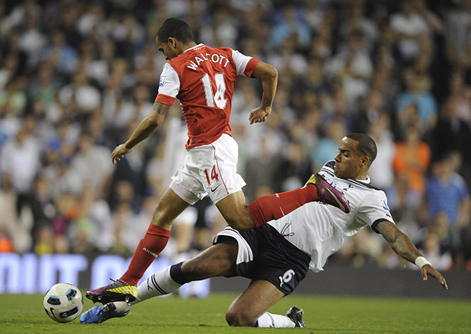 Spurs v Arsenal: Fleet-footed Walcott skips past the lunging Huddlestone