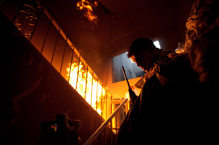 Misrata: In pictures: Libyan rebel fighters storm out of a building occupied 