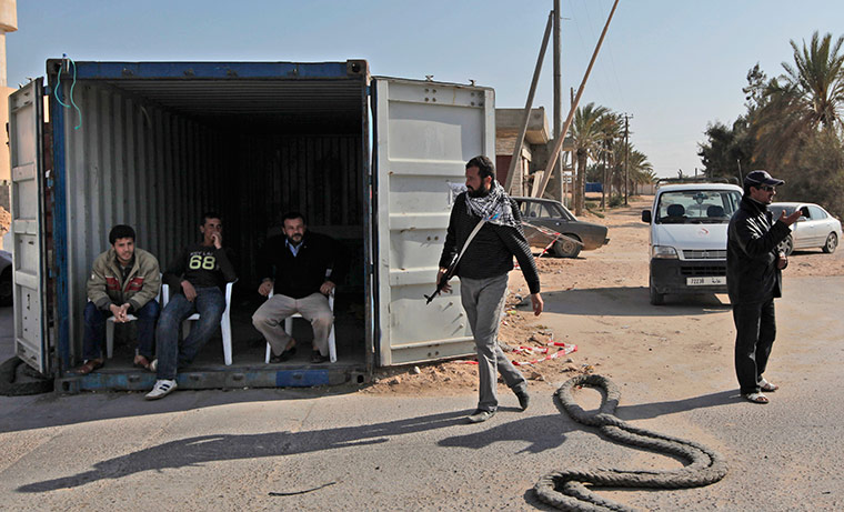 Misrata, libya:: Libyan rebel fighters guard near a checkpoint