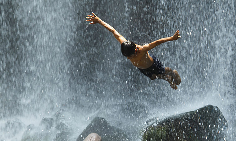 24 hours in pictures: Guanacaste city, Costa Rica: Boy jumps in the Llanos del Cortes waterfall 