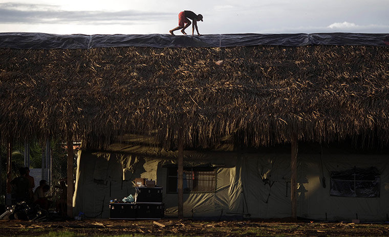 24 hours in pictures: Sao Felix, Brazil: A man works on the roof of a campaign hospital