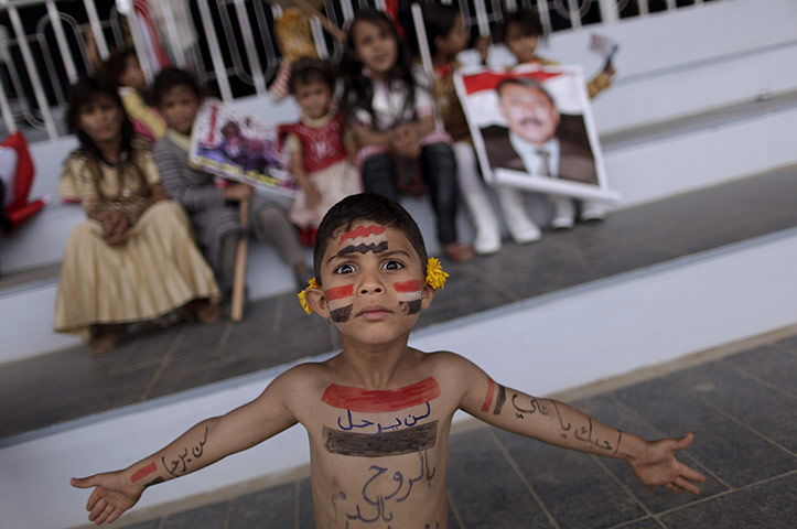 24 Hours: A boy shows his body painted with the colours of his national flag in Sanaa