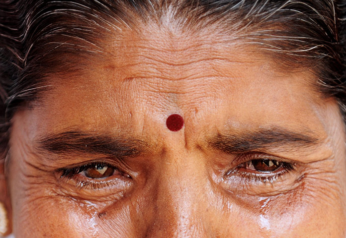 24 hours in pictures: A devotee of spiritual leader Satya Sai Baba