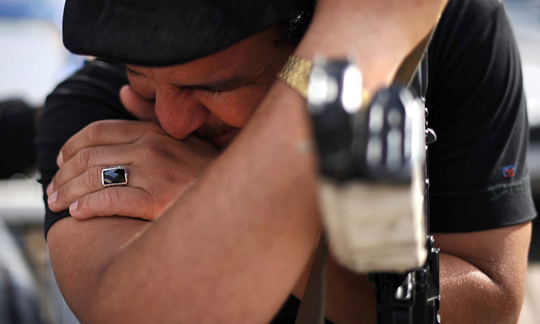 24 hours in pictures: A wounded rebel fighter mourns the death of his brother in Misrata
