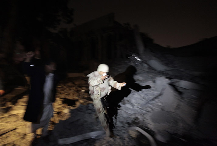 24 hours in pictures: A Libyan soldier runs at Bab al-Aziziya compound in Tripoli