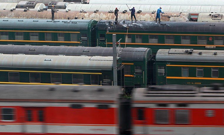 24 hours:  Workers cleaning trains in a railway station in Beijing