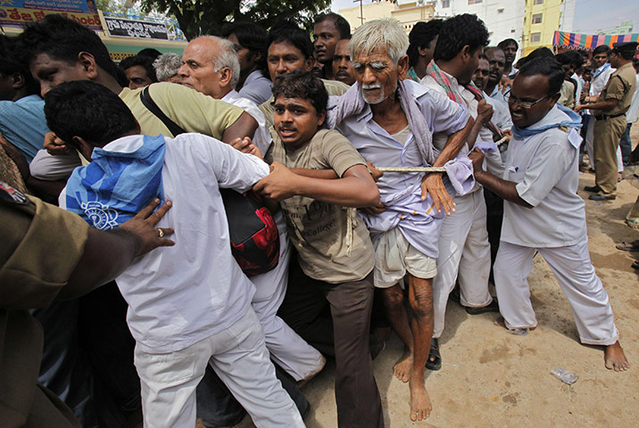 Sai Baba funeral: Security personnel try to control followers as they throng to the ashram