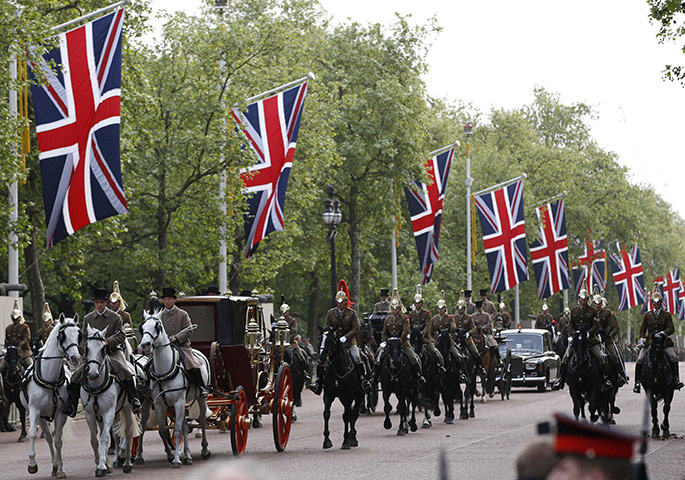 Royal Wedding rehearsal: Mounted soldiers escort a carriage down The Mall 