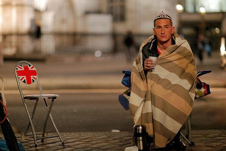 Royal Wedding rehearsal: A Royal fan sits in front of Westminster Abbey