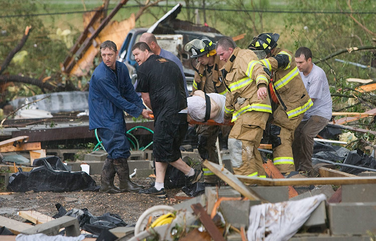 US tornado update: Rescue workers carry an elderly woman away from rubble, Alabama