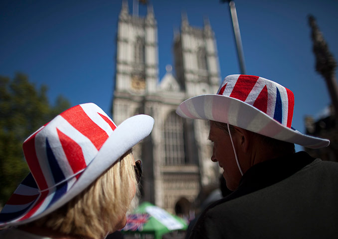 24 hours in pics: Tourists wearing Union Jack hats look on at Westminster Abbey, London