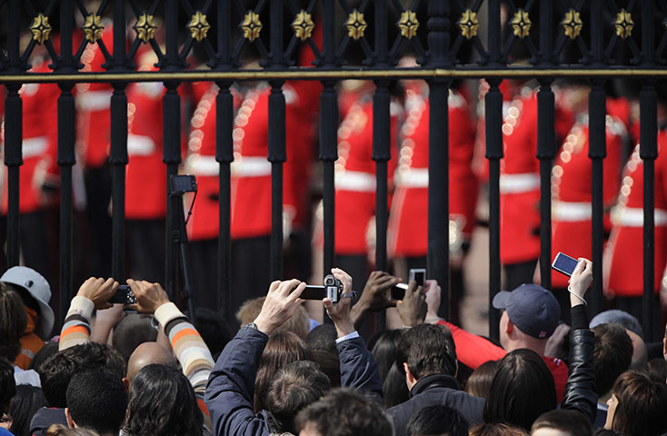 Preparations for wedding: Packed crowds taking photographs outside the gates of Buckingham Palace