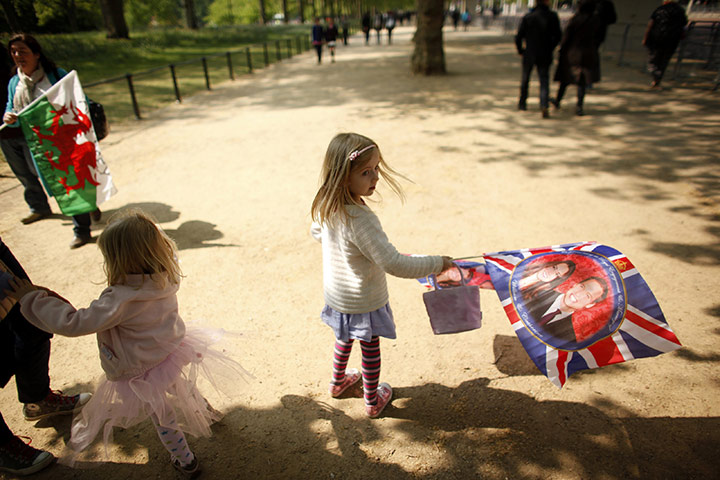 Preparations for wedding: A girl waves a souvenir flag in central London