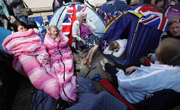 Preparations for wedding: Spectators camp out on the pavement outside Westminster Abbey