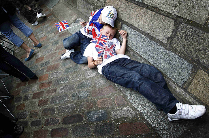 Preparations for wedding: Two boys lie on the pavement outside Westminster Abbey 