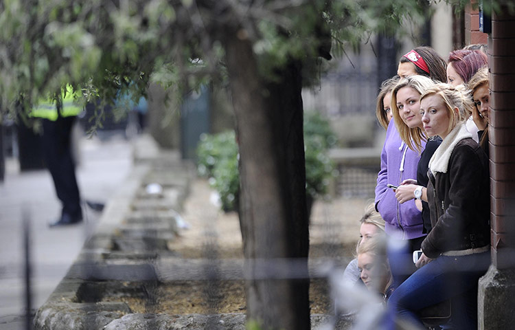 Preparations for wedding: Young women stand opposite The Goring hotel in central London