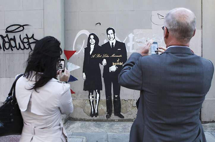 Preparations for wedding: Passers-by photograph street art depicting Prince William and Kate