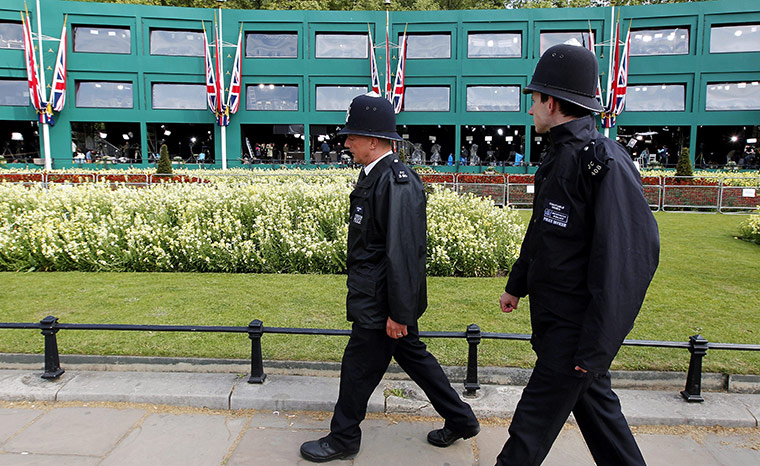 Preparations for wedding: Two British police officers walk by the media studios at Buckingham Palace 
