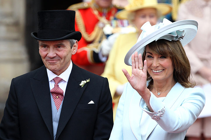 Wedding procession: Michael and Carole Middleton smile and wave