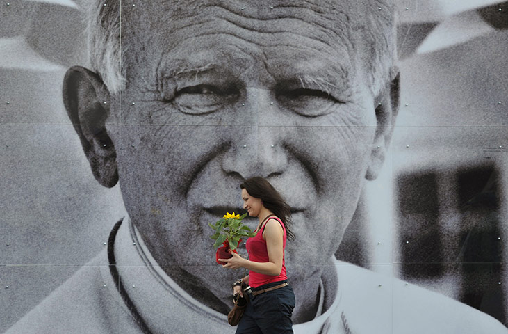 24 hours in pictures: A giant poster of the late Pope John Paul II in downtown Krakow, Poland
