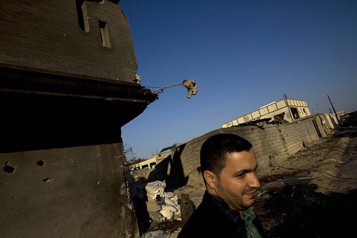 24 hours in pictures: A Libyan man walks past destroyed buildings, Misrata, Libya