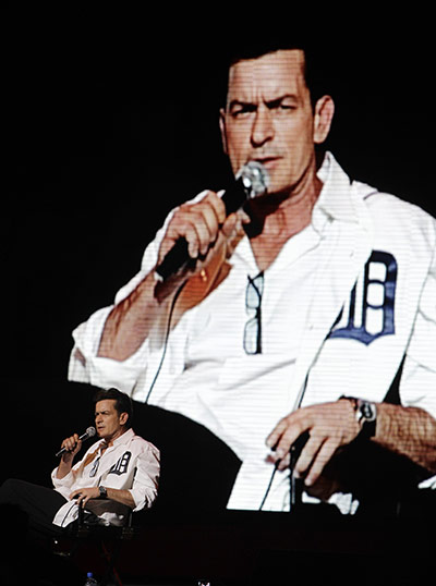 Charlie Sheen's show: An image of Charlie Sheen is projected in the background as he performs