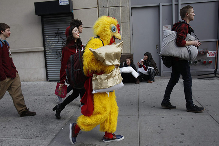 Pillow fight day: New York City, USA: A person in a chicken suit walks down the street 