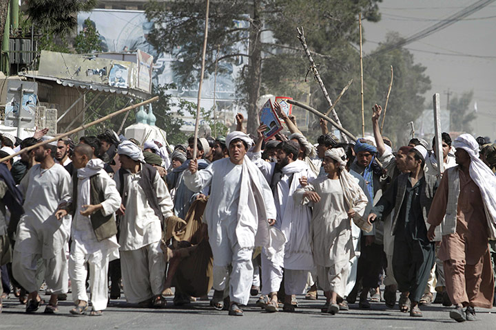 Afghanistan protests: Afghan protesters walk with sticks in Kandahar 