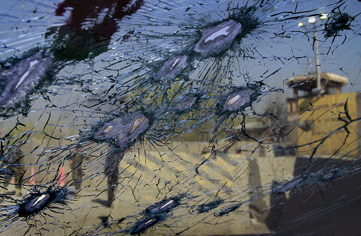Afghanistan protests: Afghan soldiers are seen through the front window of a car 