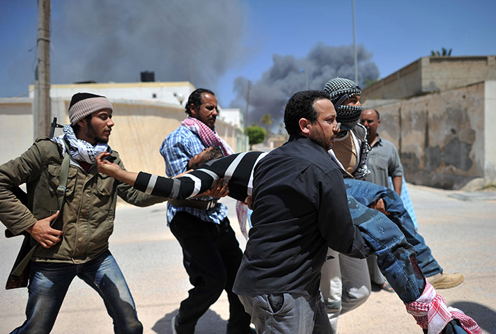 24 Hours: Rebels carry a comrade who was wounded in Misrata