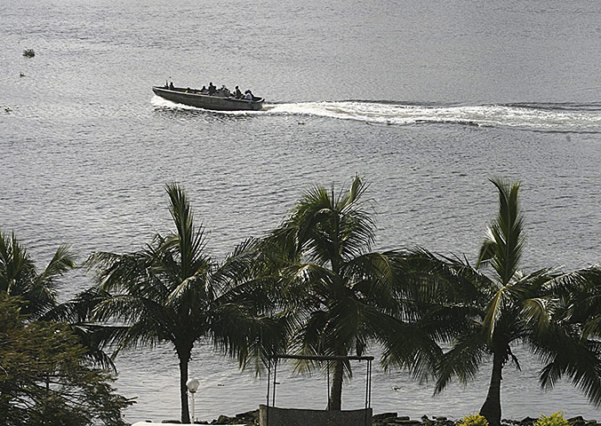 ivory coast: Forces loyal to Laurent Gbagbo patrol on the Ebrie lagoon in Abidjan