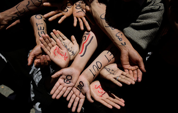 24 hours in pictures: Anti-government protestors display their arms and hands, Yemen