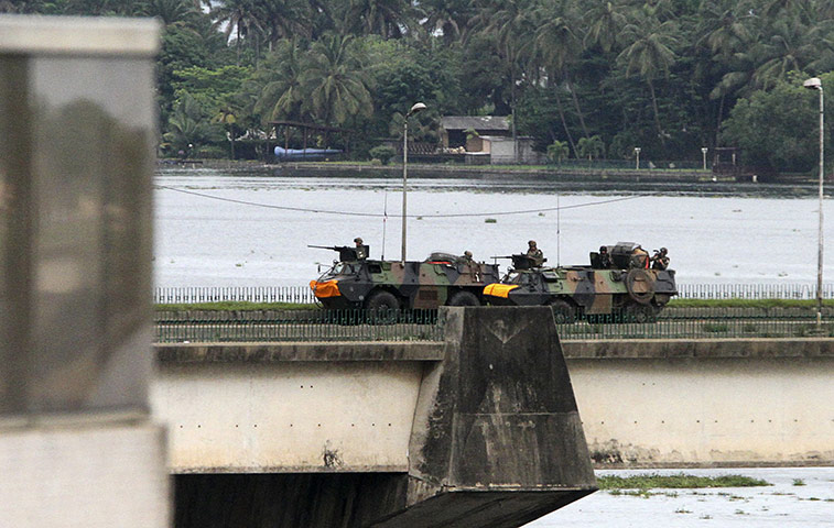 Ivory Coast: 5 April: French armoured personnel carriers cross General de Gaulle bridge